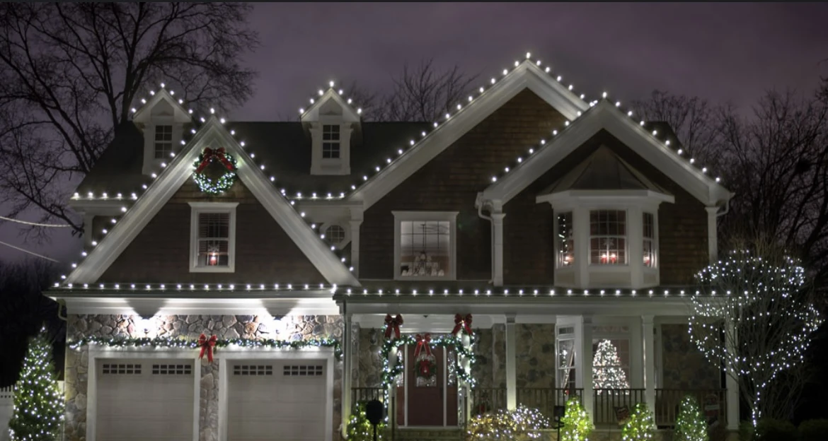 Christmas light installation on a Calallen home with wrapped trees in Corpus Christi